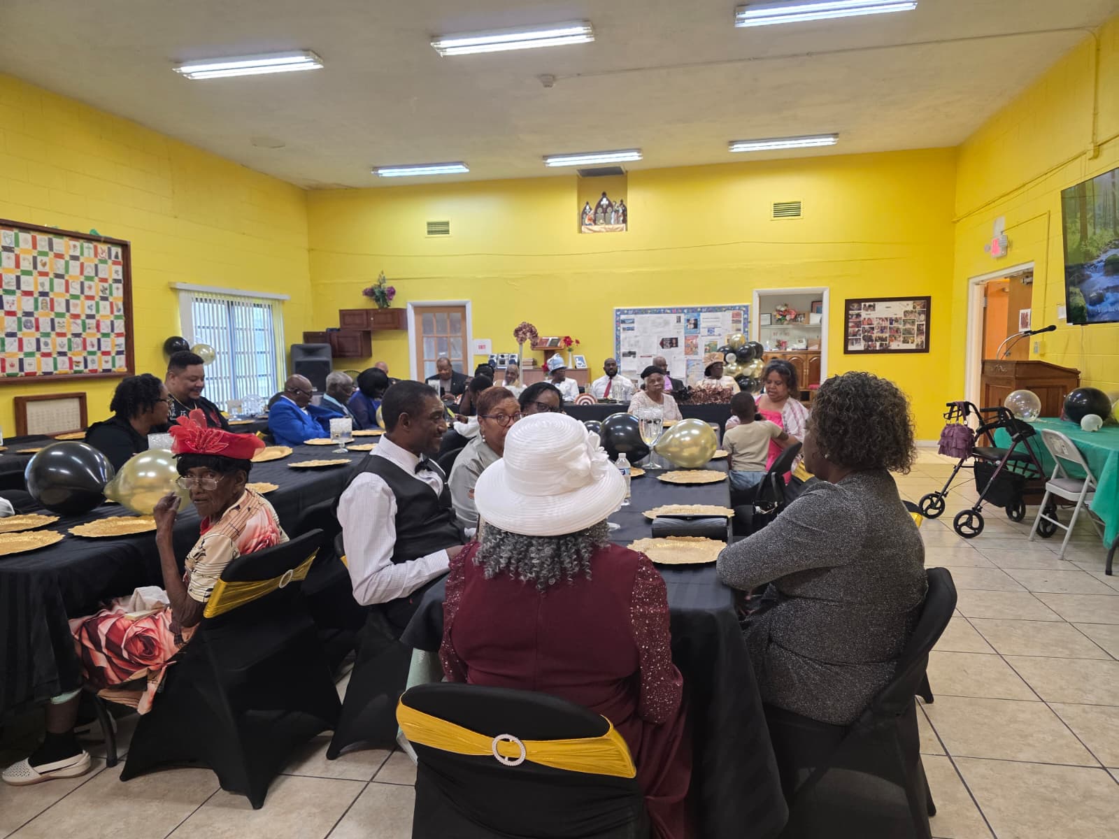 People gathered around tables at a community event