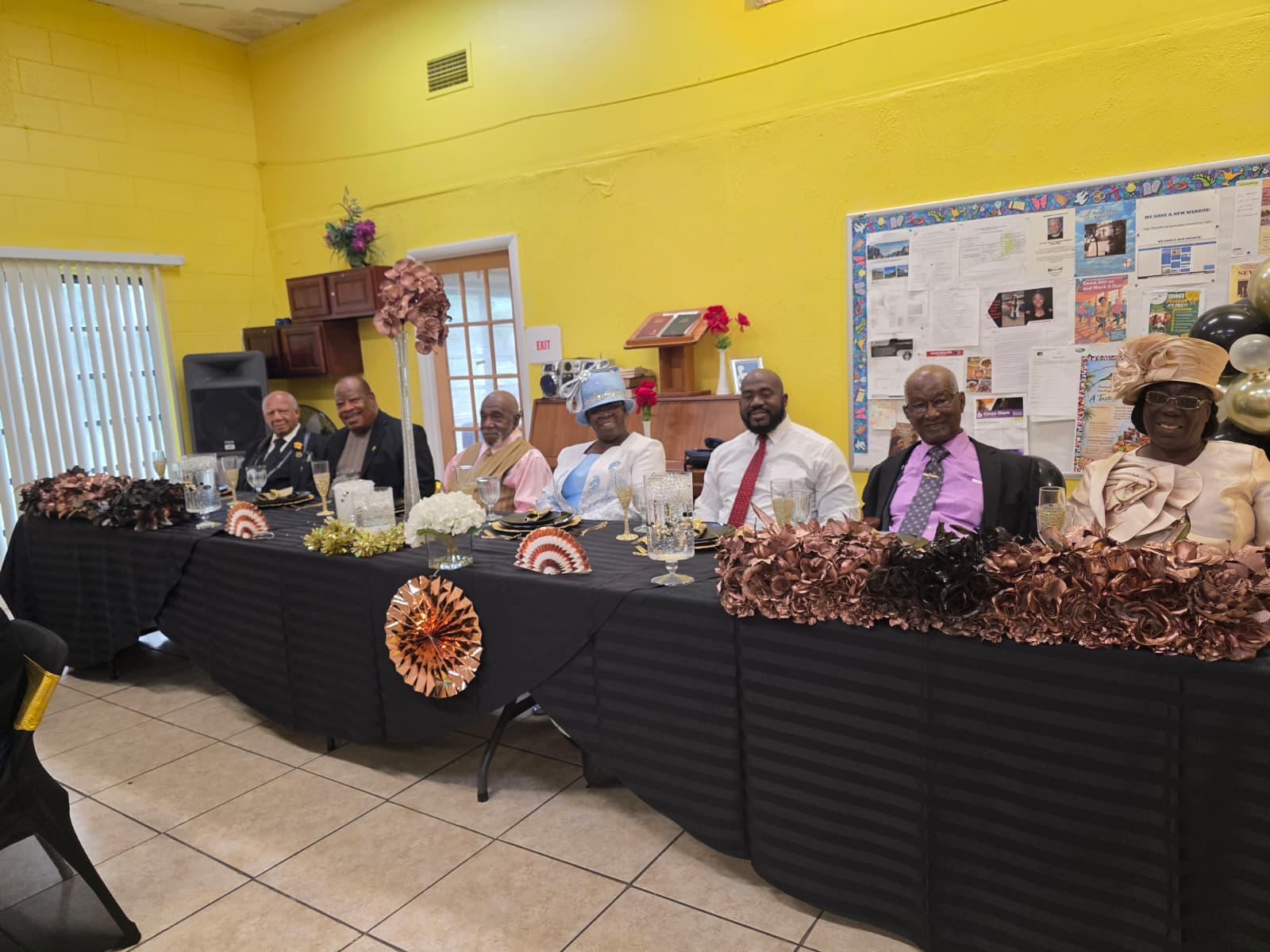 Community members seated together at an event table