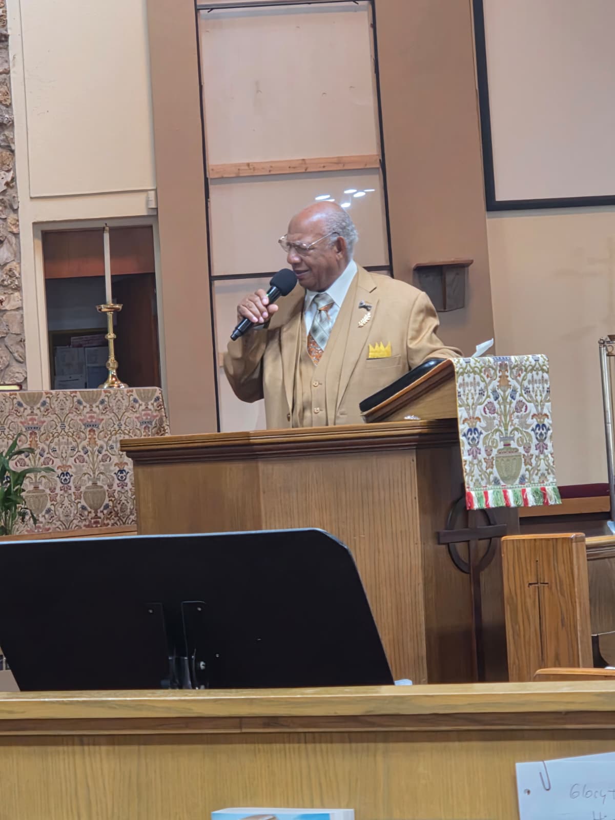 A man speaking at a church lectern