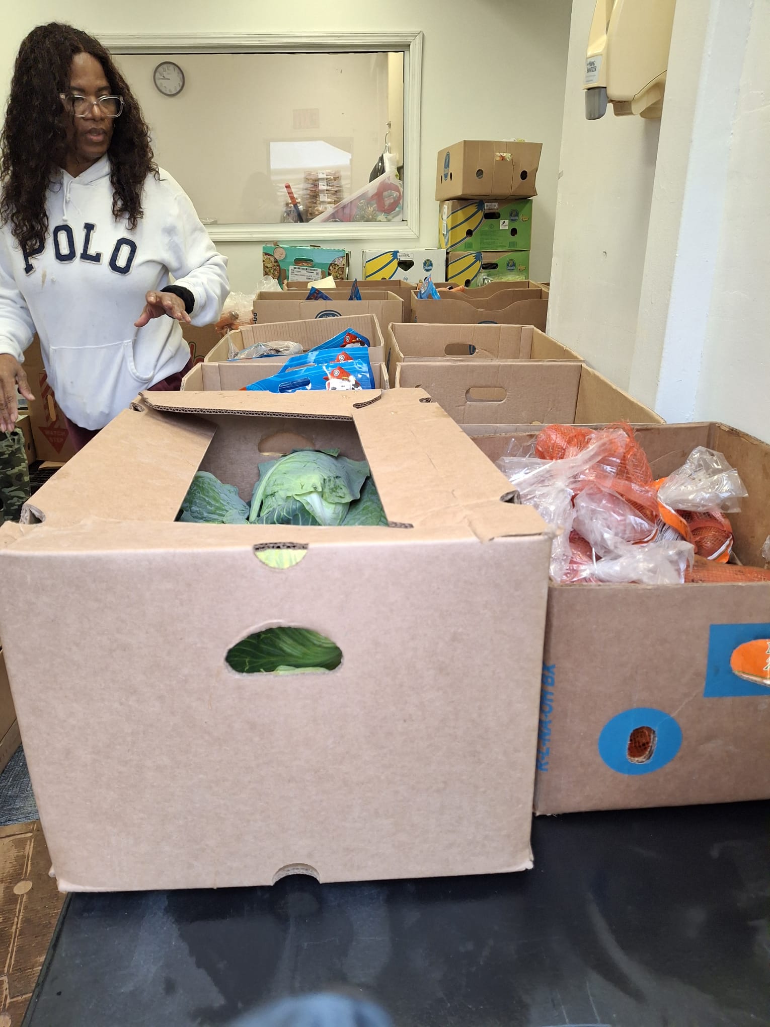 A volunteer working with boxes of food