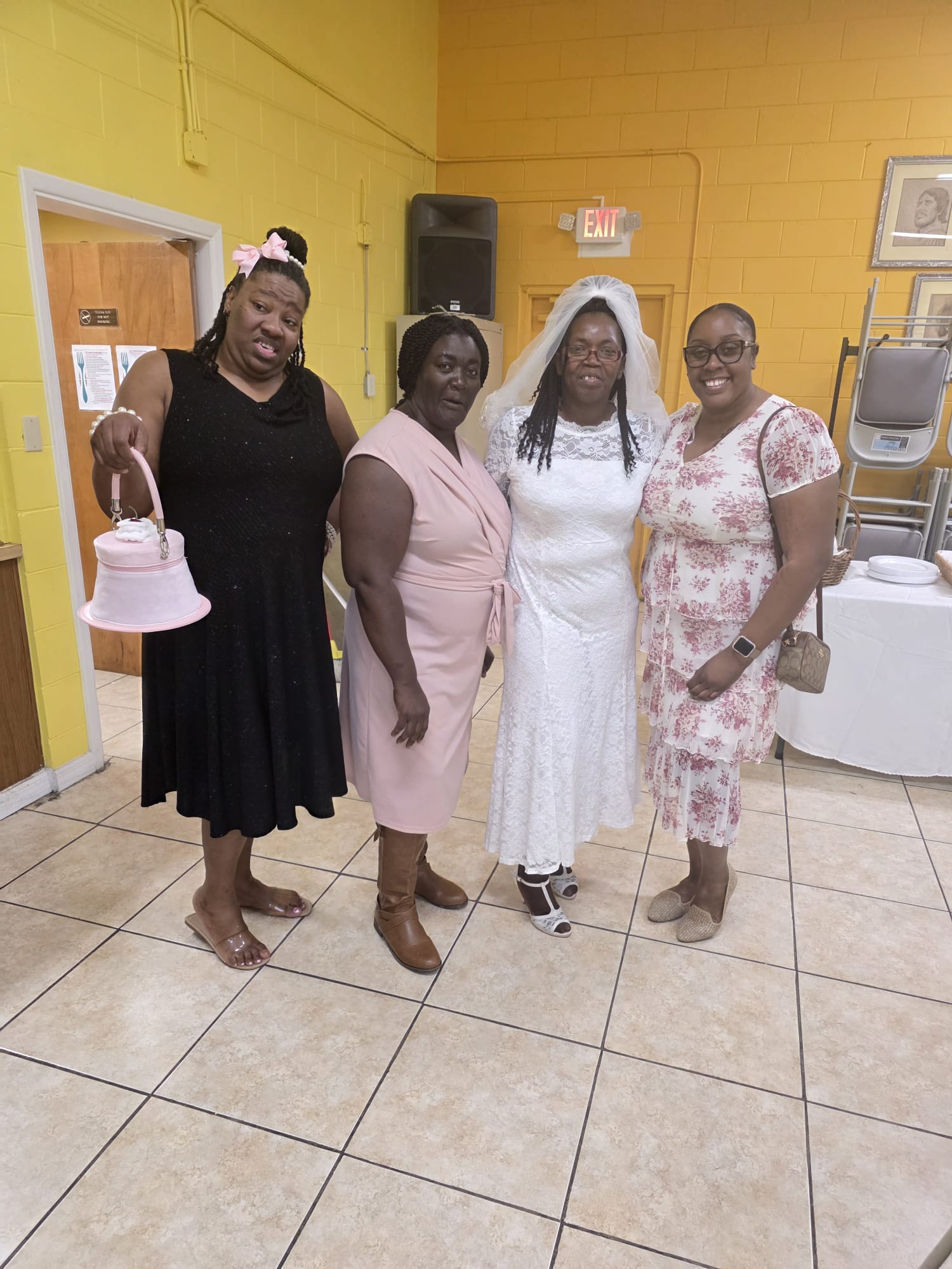 Four women standing together at a gathering